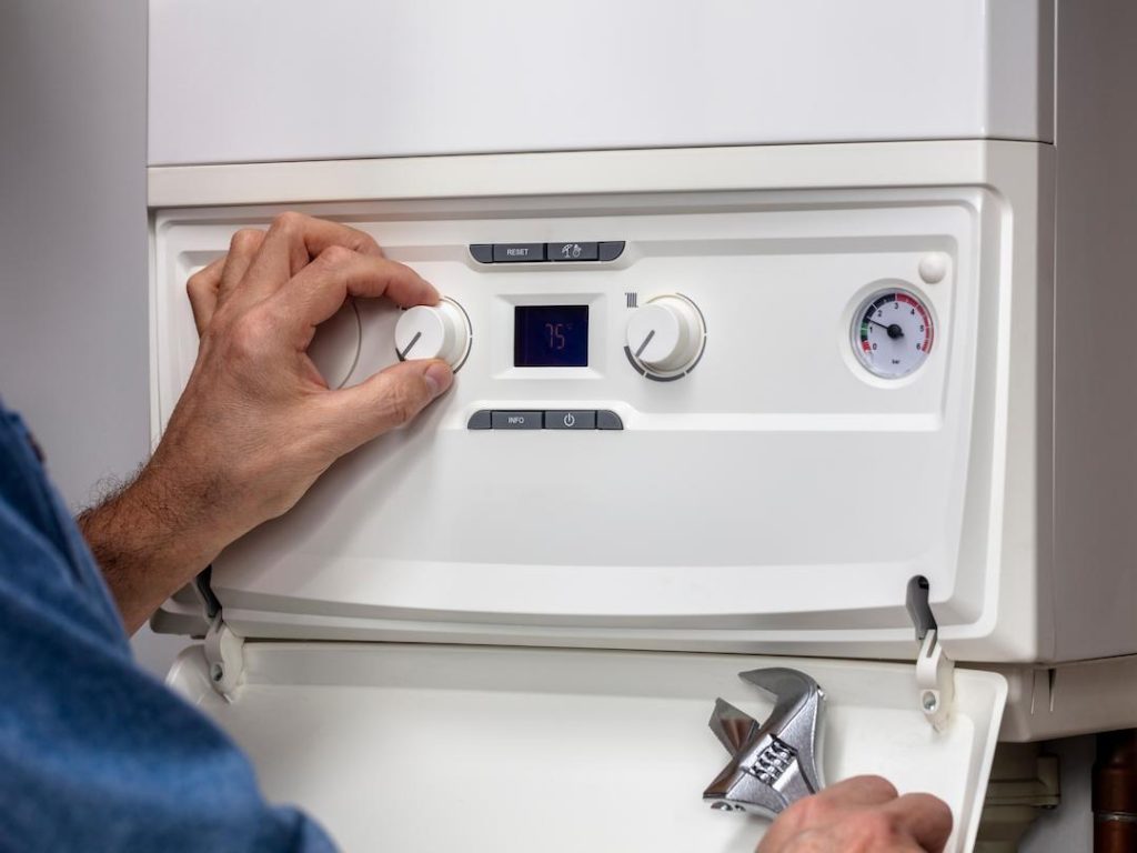 Plumber Servicing A Boiler