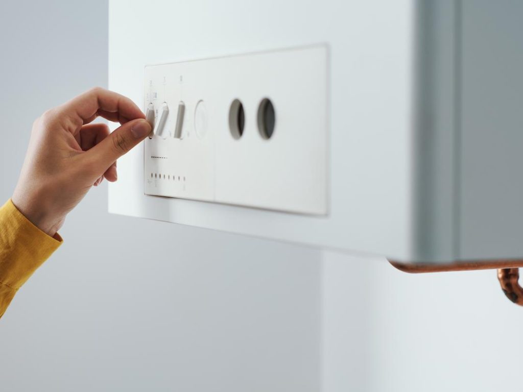 Woman Adjusting Her Boiler